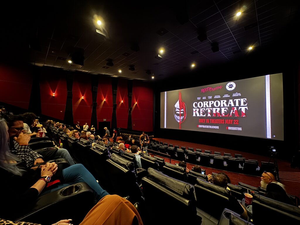 Audience attending the Corporate Retreat premiere inside a movie theater.
