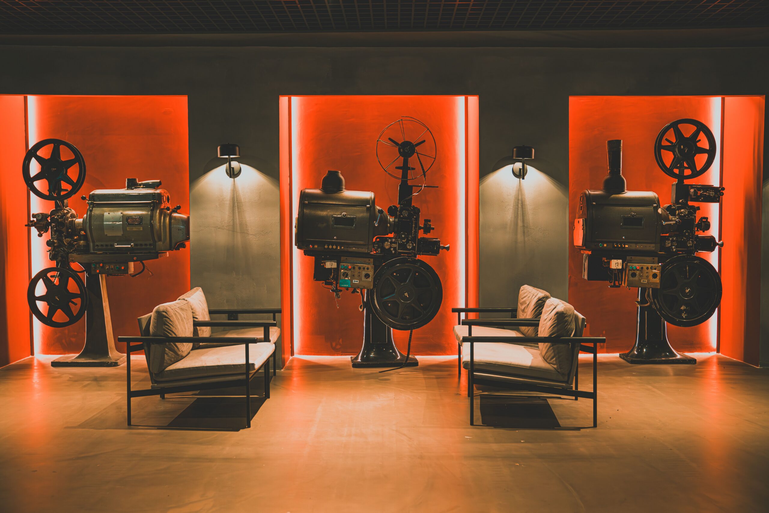 Old movie projectors set up as decor in a modern lobby